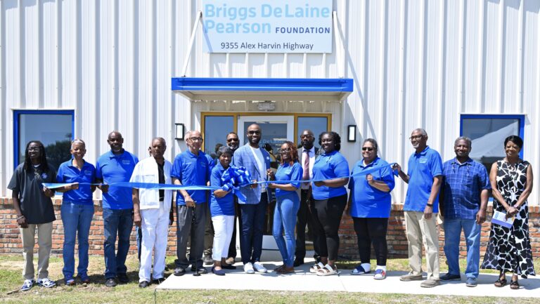 BDPF Ribbon Cutting for Education Building L-R: Jazlynn Bowman, Council Member, Summerton Town Council; Celeste Boykin, BDPF Board Member; Clayton Pack, BDPF Board Member; Darreyl Walker (partially hidden) BDPF Board Member; Hezekiah House, former BDPF Board Chair; Matt Grayson (partially hidden), BDPF Board Member; Joseph De Laine, Jr., BDPF Board Member; Marguirite De Laine, BDPF Board Chairperson, Wayne Stewart, BDPF Board Member; Jason Montgomery, President Clarendon County Chamber of Commerce; Margo Stukes, BDPF Board Member; Keith Bowman, Mayor of Summerton; Lanitra Bennett, BDPF Board Member; Shirley Mitchell, BDPF Board Member; Thomas Bradford, BDPF Board Member; John Bonaparte, Board Chairman, Clarendon County School District; Julia Nelson, Mayor of Manning.